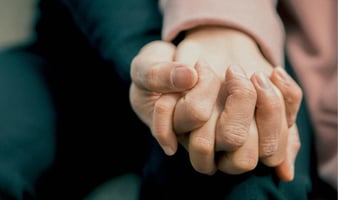 Parent holding child's hand