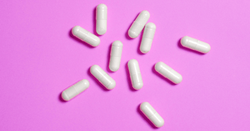 HRT pills on pink background