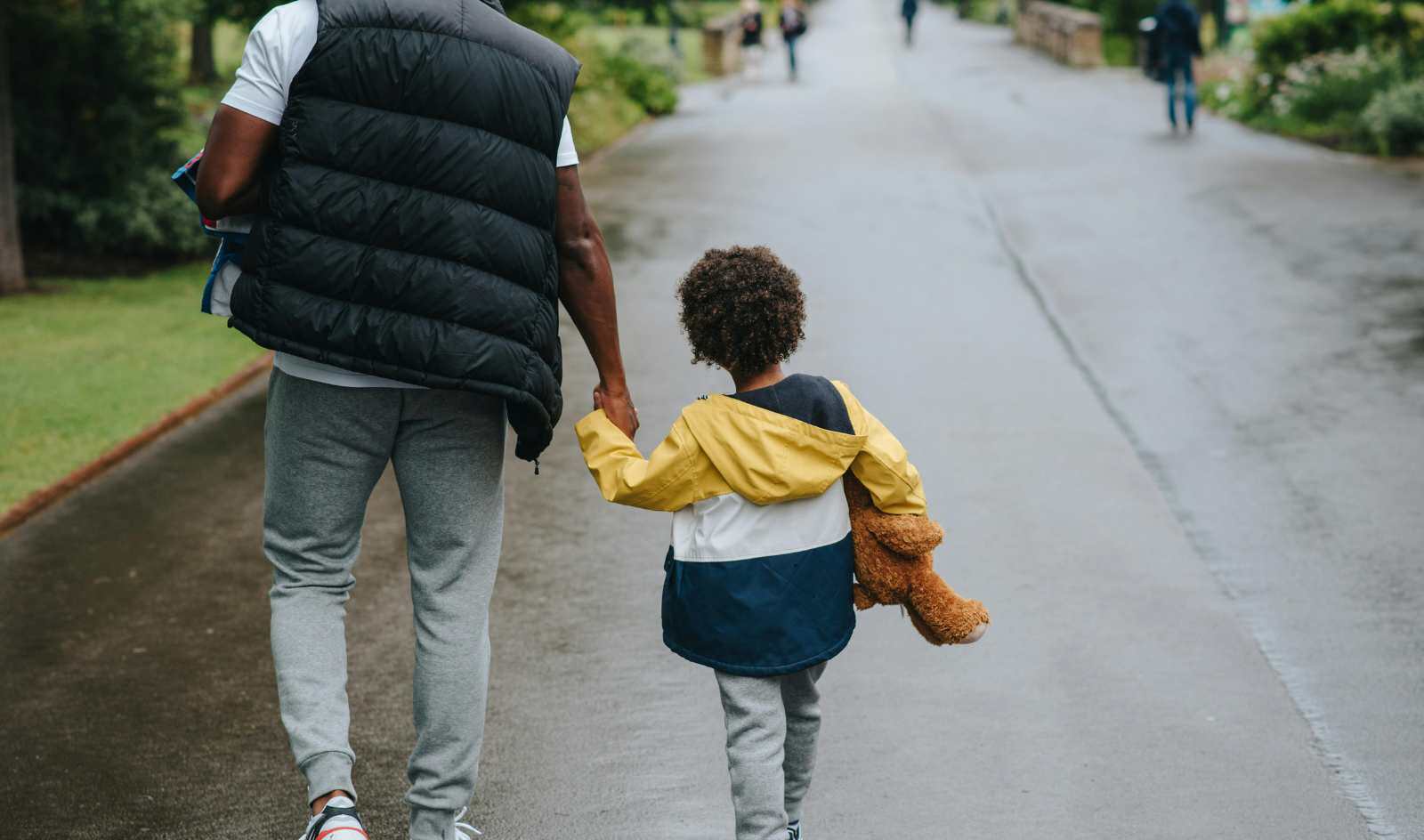 Parent and child walk together hand in hand