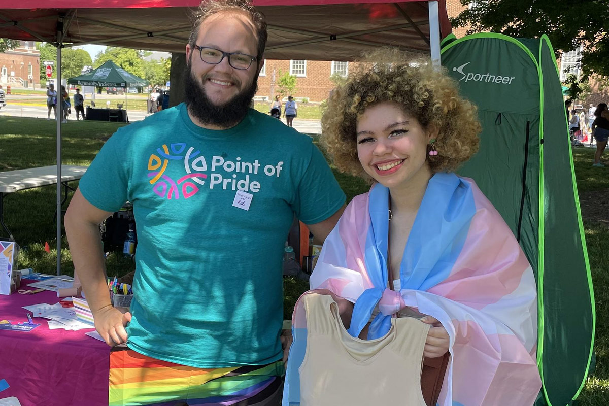 Point of Pride staff with a chest binder recipient at a LGBTQ+ Pride event