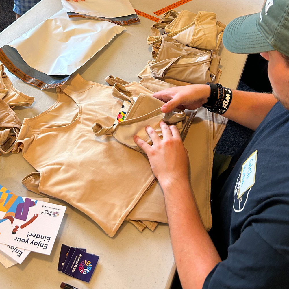 A volunteer packaging a chest binder